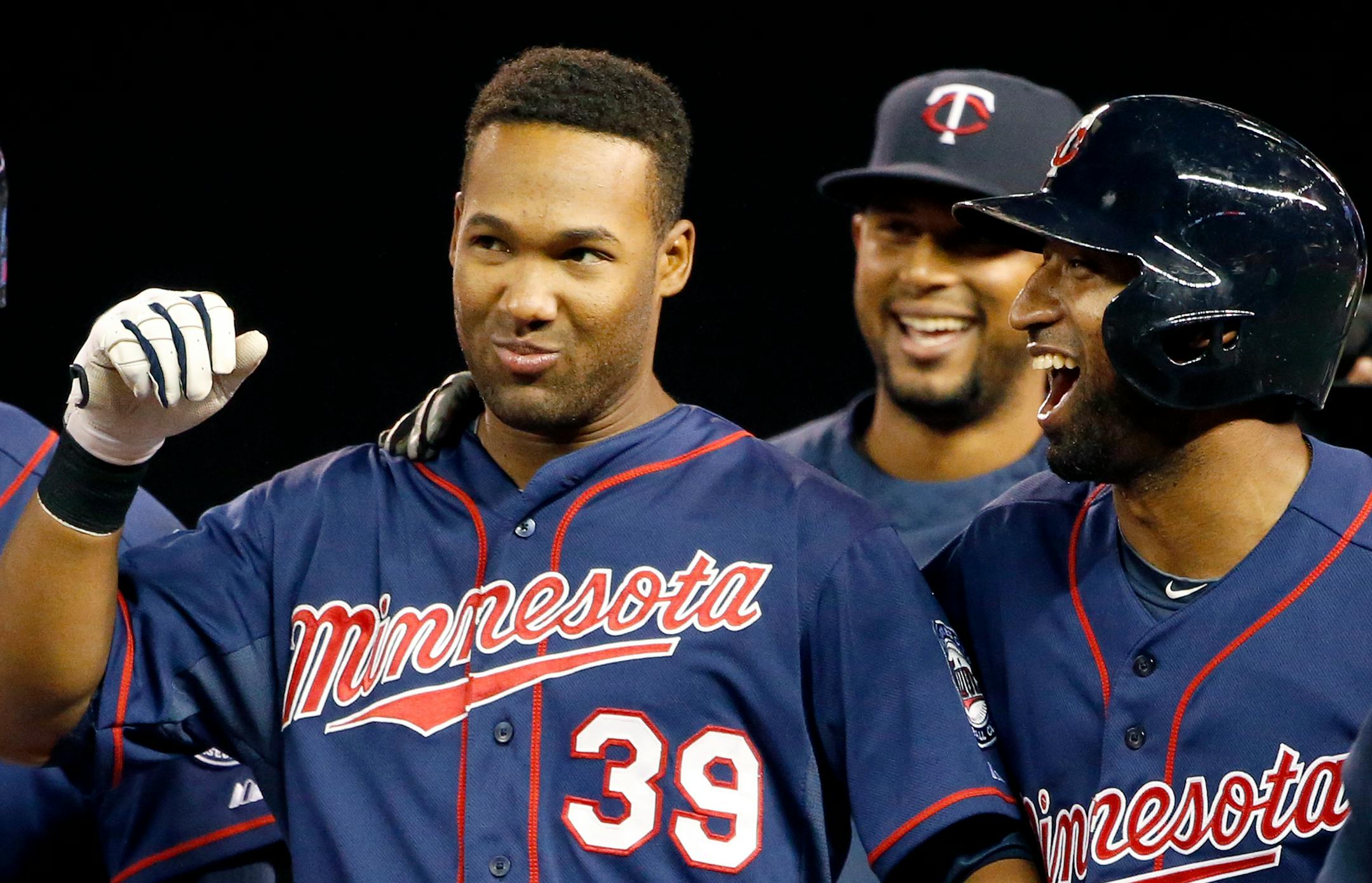 Danny Santana (39) and Eduardo Nunez (9) celebrated at the end of the game. Minnesota beat Texas by a final score of 4-3.