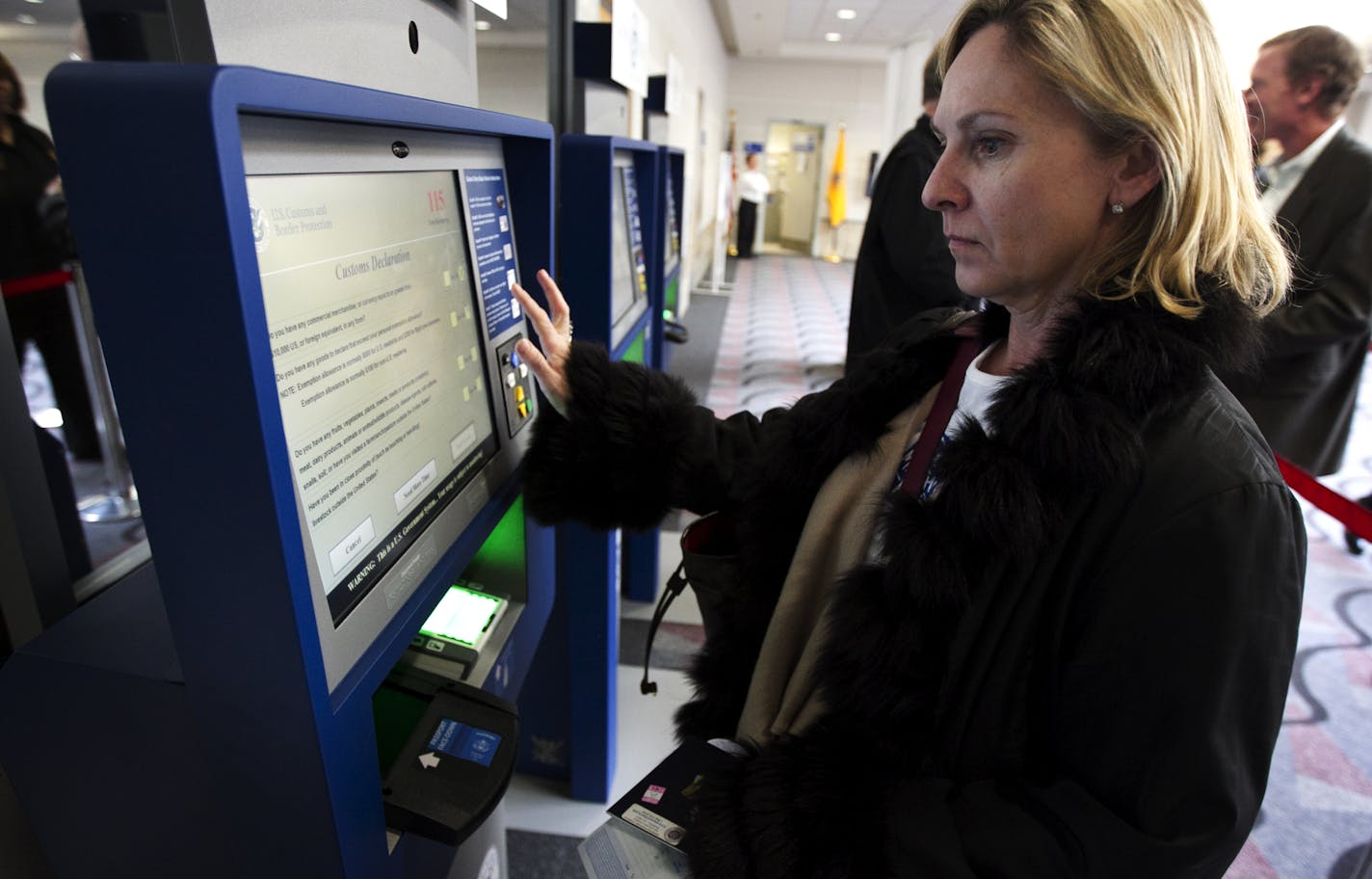 Maureen Chatelain of Atlanta, GA used the new Global Entry System to clear custom at the Minneapolis Airport after arriving from Paris France Monday March 5, 2012.The system helps international passengers to clear immigration without standing in long lines.](Jerry Holt/ STAR TRIBUNE/jgholt@startribune.com)