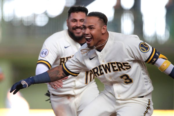 Milwaukee's Orlando Arcia celebrates with teammates after driving in the winning run during the 10th inning of the team's Opening Day game against the