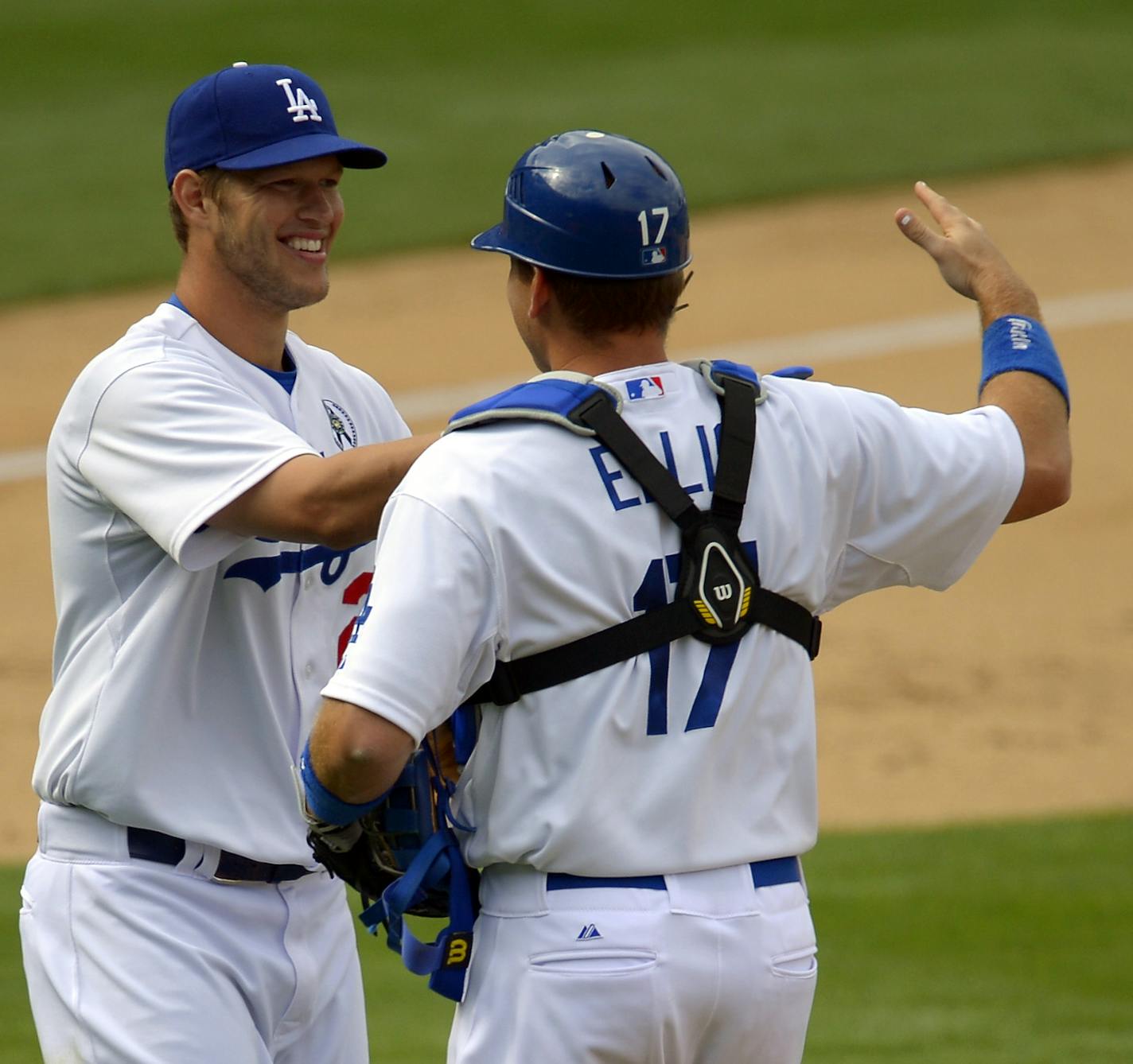 Los Angeles Dodgers starting pitcher Clayton Kershaw, left, is congratulated by catcher A.J. Ellis after they defeated the San Francisco Giants in their opening day baseball game at Dodger Stadium, Monday, April 1, 2013, in Los Angeles. The Dodgers won 4-0. (AP Photo/Mark J. Terrill)