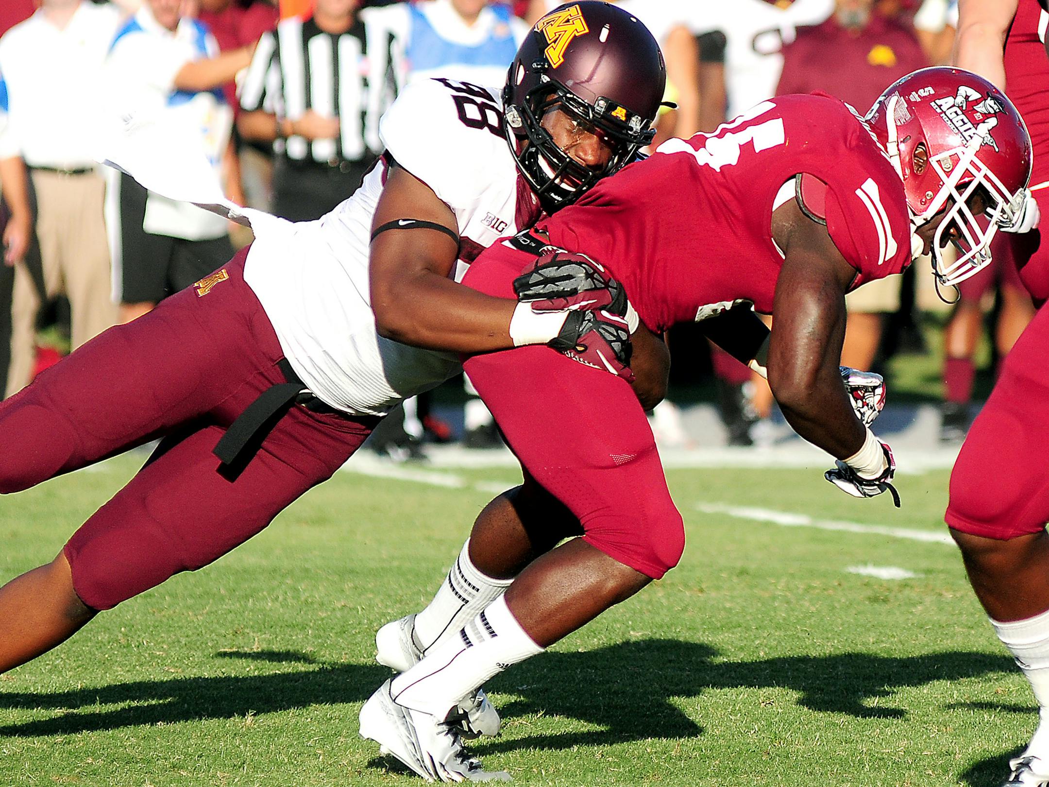 Photos by Shari Vialpando-Hill Minnesota University defensive end Michael Amaefula brings down New Mexico State running back Germi Morrison during the first half of the game at Aggie Memorial Stadium on Saturday in Las Cruces, N.M.