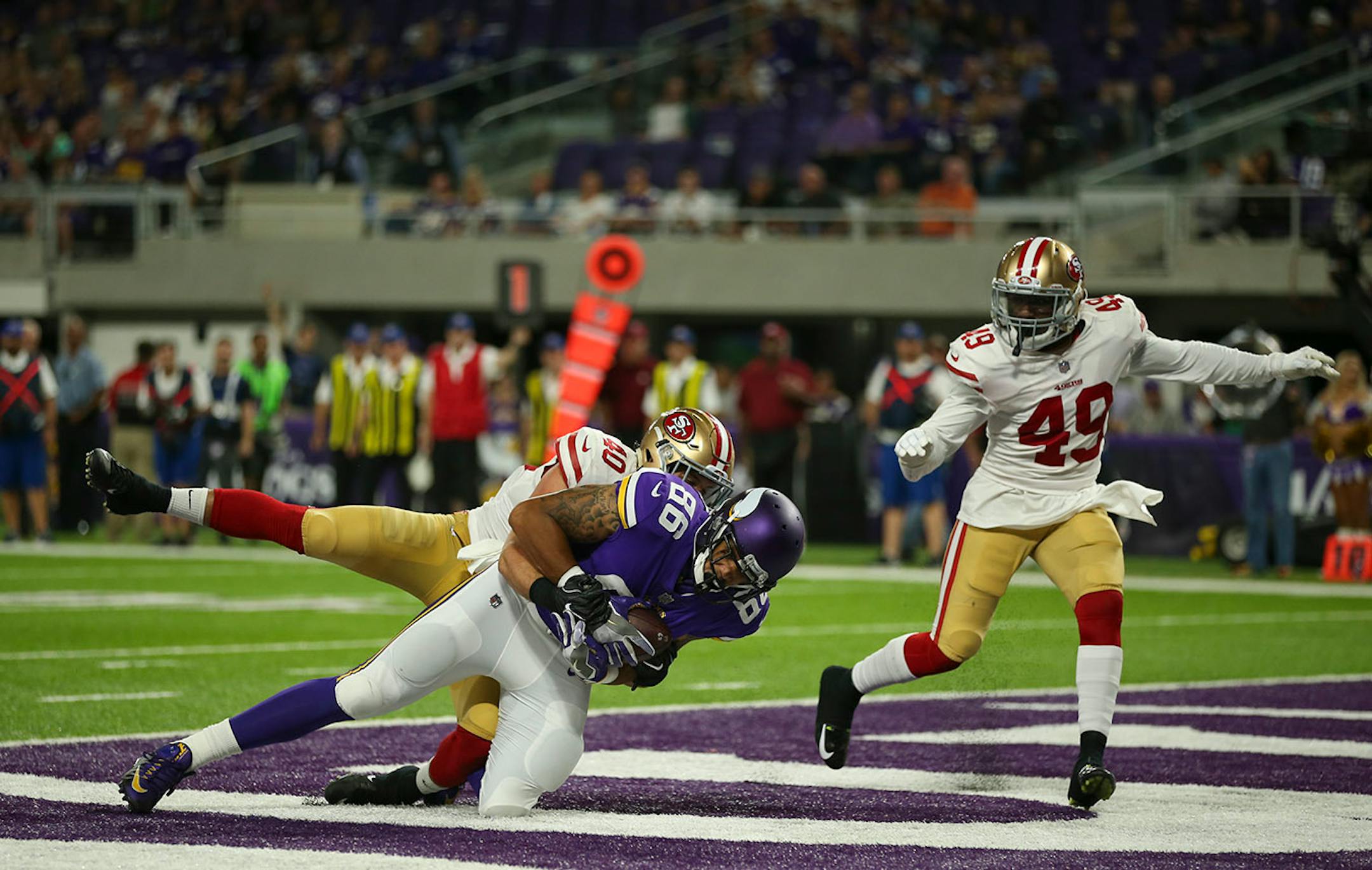 Minnesota Vikings tight end Kyle Carter (86) was tackled in the end zone by San Francisco 49ers defensive back Vinnie Sunseri (40) after a 16 yard reception.