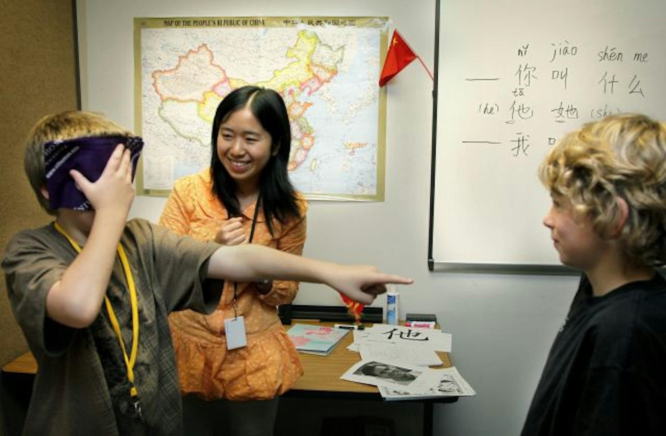 Xing Bei played a game at Rosemount Middle School with Nicolaus Fedorenko, behind the blindfold, and Logan Timbers. They had to ask questions in Mandarin to find out who they were talking to. Xing teaches English back home in China.