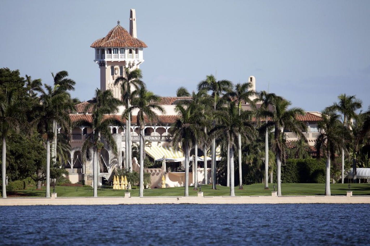 FILE- This Monday, Nov. 21, 2016 file photo, shows the Mar-a-Lago resort owned by President-elect Donald Trump in Palm Beach, Fla. President Donald Trump's Mar-a-Lago is reopening after being closed during the brutal heat and humidity of Florida's summer. If last season is a guide, the president will soon visit his Winter White House, staying several days at Thanksgiving, Christmas and New Year's and then return many more weekends until May.