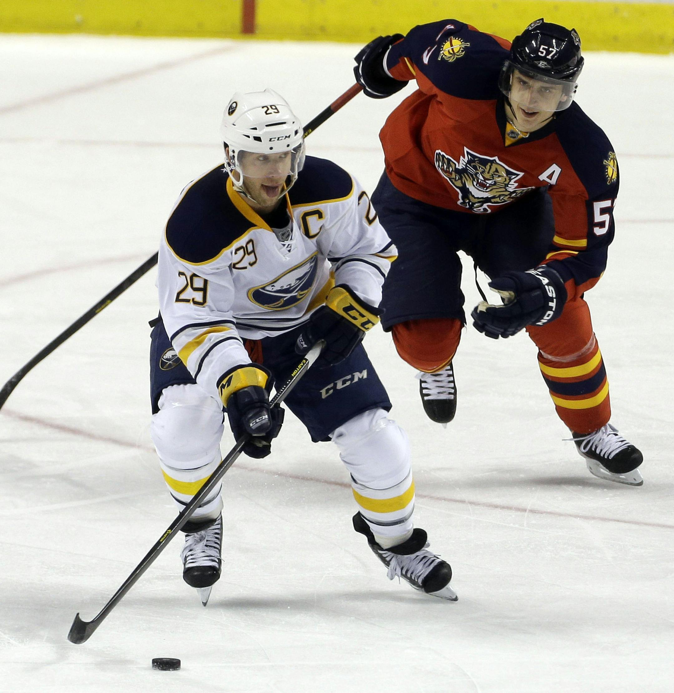 Flroida Panthers' Marcel Goc (57) chases Buffalo Sabres' Jason Pominville (29) as they chase the puck during the second period of an NHL hockey game in Sunrise, Fla., Thursday, March 28, 2013. (AP Photo/J Pat Carter)