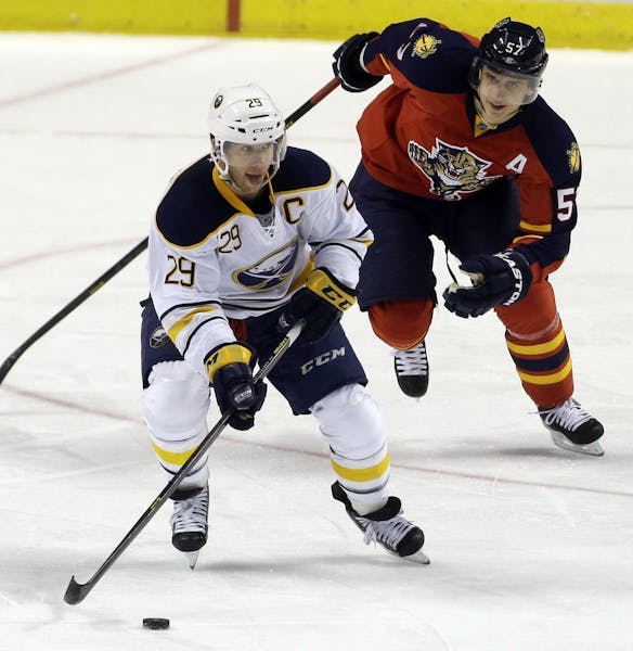 Flroida Panthers' Marcel Goc (57) chases Buffalo Sabres' Jason Pominville (29) as they chase the puck during the second period of an NHL hockey game i