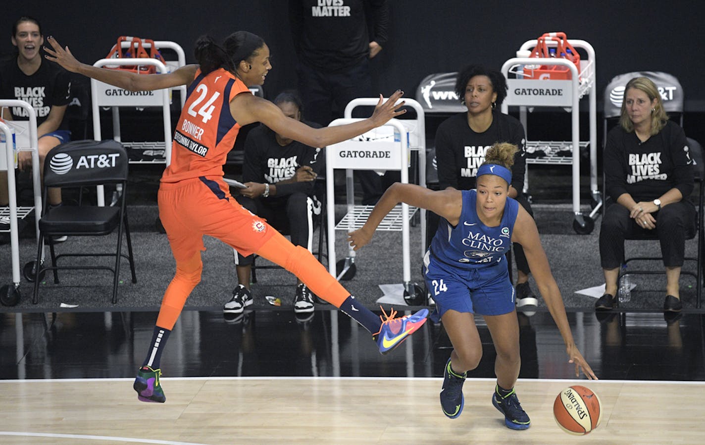 Minnesota Lynx forward Napheesa Collier, right, drives past Connecticut Sun forward DeWanna Bonner (24) during the second half of a WNBA basketball game, Sunday, July 26, 2020, in Bradenton, Fla. (AP Photo/Phelan M. Ebenhack)