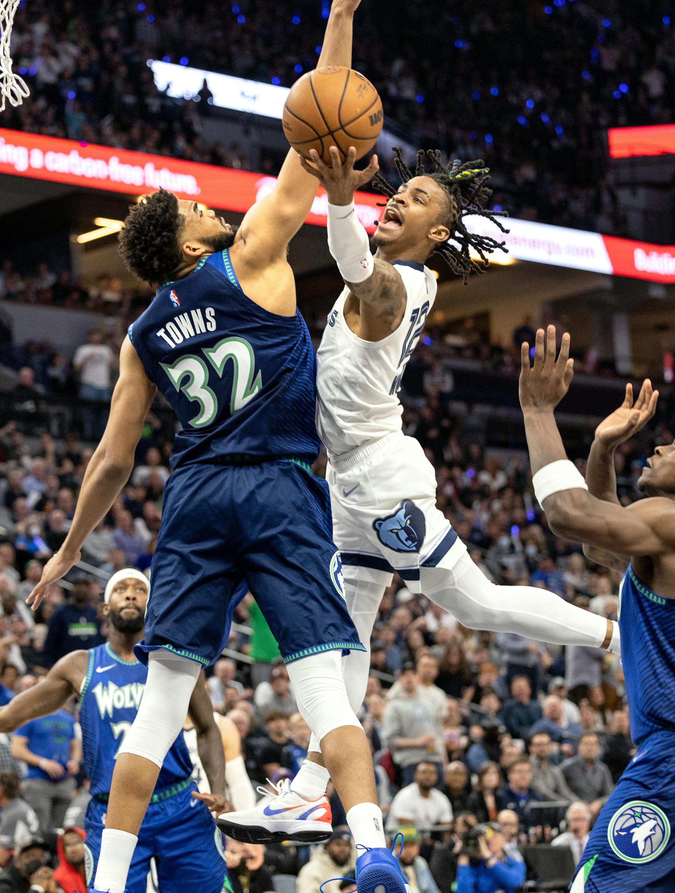 Karl Anthony-Towns (32) of the Minnesota Timberwolves defends Ja Morant (12) of the Memphis Grizzlies in the second quarter.