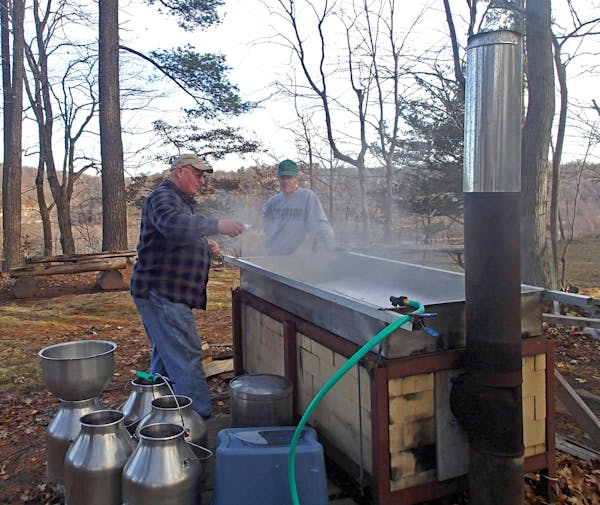 John Weyrauch, left, and John Miller began cooking about 400 gallons of maple sap early Thursday morning, a process that will continue more than two d
