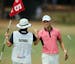 Golfer Martin Kaymer of Dusseldorf, Germany, right, fist bumps his caddy, Craig Connolly, after an eagle on the fifth hole during the third round of t