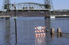 A walkway was underwater with the Stillwater Lift Bridge seen to the rear along the St. Croix River during spring flooding Tuesday March 31, 2020, in 
