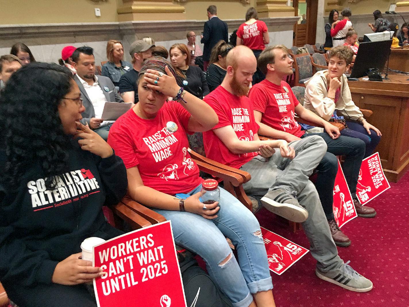 Supporters of raising the city minimum wage to $15 an hour fill the Minneapolis City Council chambers before the start of a council committee hearing Wednesday in Minneapolis.