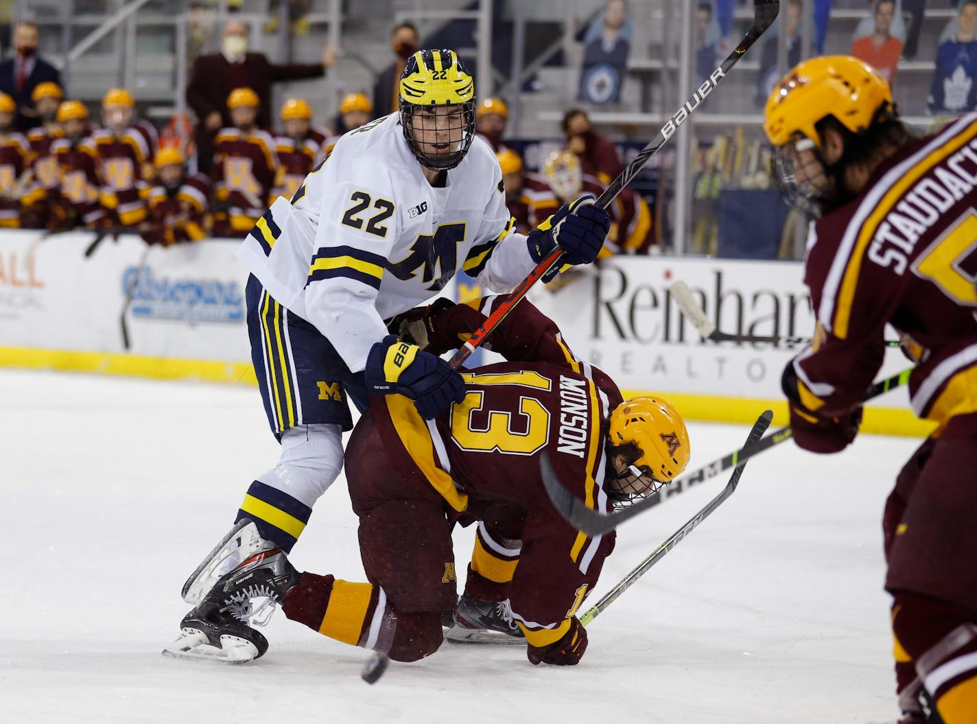 FILE - In this Dec. 8, 2020, file photo, Michigan's Owen Power (22) watches the puck while working against Minnesota's Cullen Munson (13) during an NCAA hockey game in Ann Arbor, Mich. The NHL Central Scouting Bureau has three Michigan players listed among its top six North American prospects, led by 6-foot-6 defenseman Power, the top-ranked player, who is current representing Canada at the World Hockey championships in Latvia. (AP Photo/Al Goldis, File)