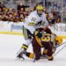 FILE - In this Dec. 8, 2020, file photo, Michigan's Owen Power (22) watches the puck while working against Minnesota's Cullen Munson (13) during an NC