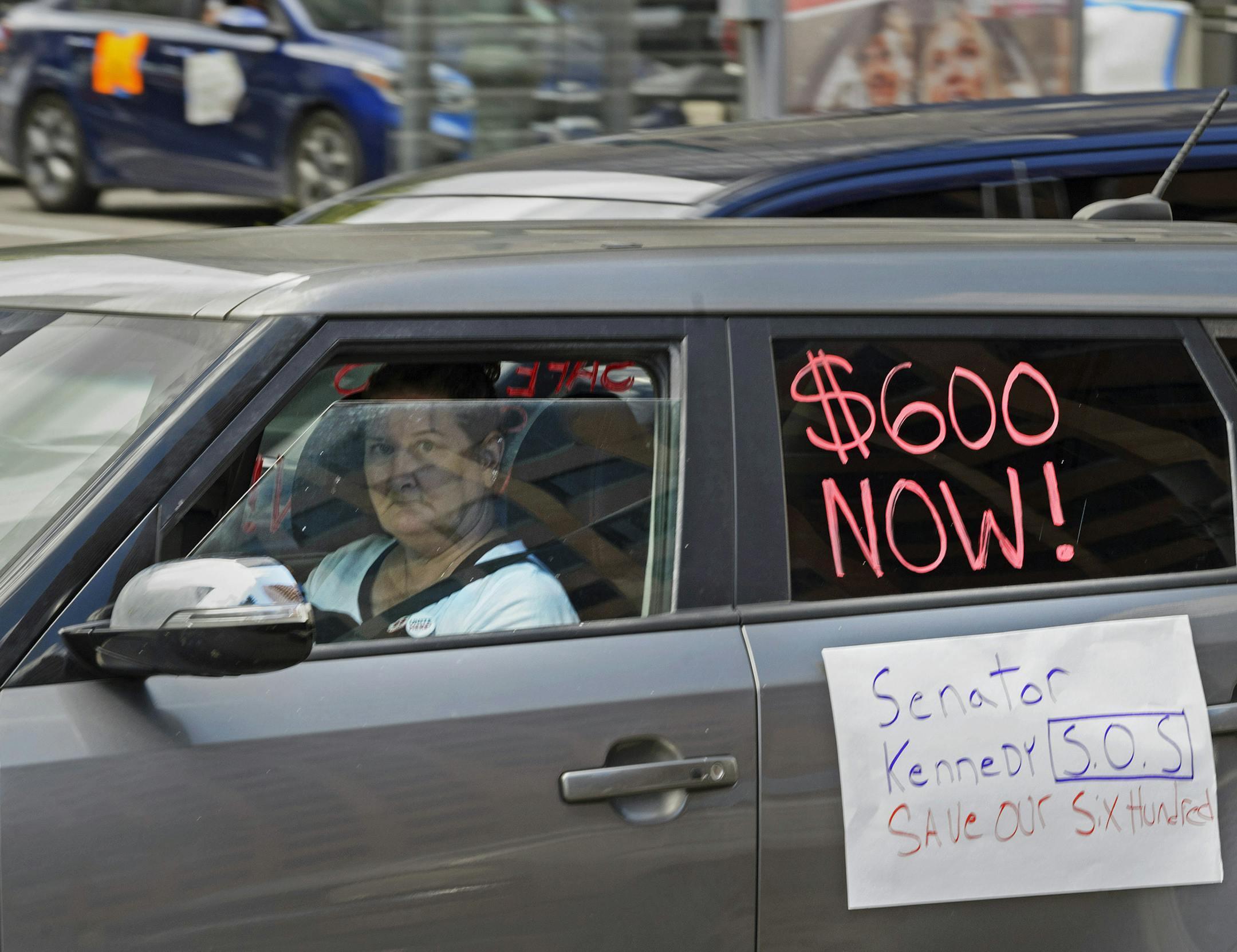 Motorists take part in a caravan protest in front of Senator John Kennedy's office at the Hale Boggs Federal Building asking for the extension of the $600 in unemployment benefits to people out of work because of the coronavirus in New Orleans, La. Wednesday, July 22, 2020. (Max Becherer/The Advocate via AP)