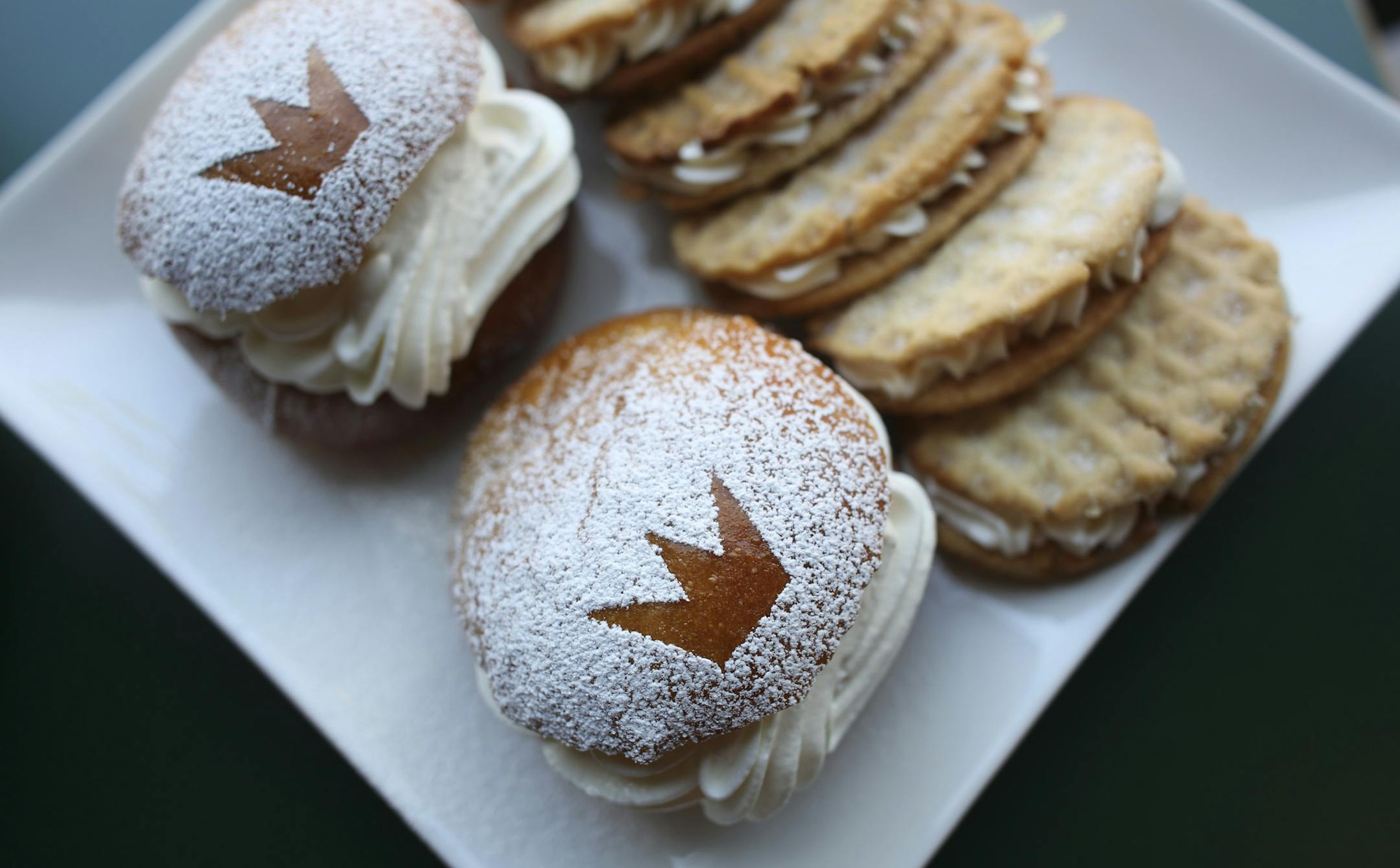 Swedish Semlas, left, and Parisian waffles made atthe Swedish Crown Bakery, at Grass Roots Co-op in Anoka, Min., Wednesday, May 15, 2013. The Swedish Crown Bakery is planning to expand their business less than a mile away from the Co-op. ] (KYNDELL HARKNESS/STAR TRIBUNE) kyndell.harkness@startribune.com