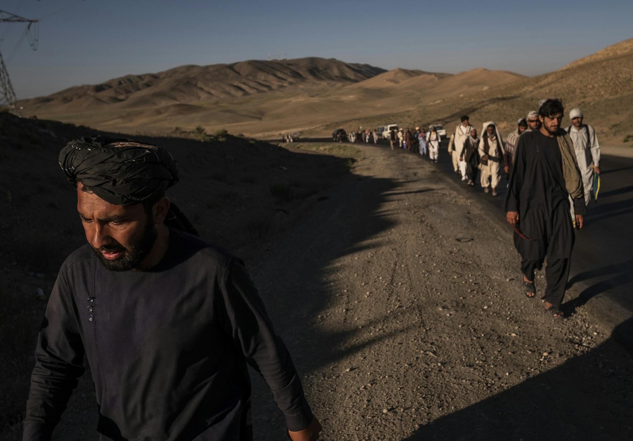 FILE-- Members of a peace march walking to Wardak, Afghanistan, from Ghazni, June 12, 2018. Afghanistan’s quixotic band of peace marchers invaded the heart of Taliban territory in early June 2019, and finally succeeded in their long-delayed quest to sit down with the Afghan government’s enemy. The marchers also said they found that both the Taliban and the Afghan government had the same sort of leaders — unwilling to make the kinds of compromises that could end the war (Jim