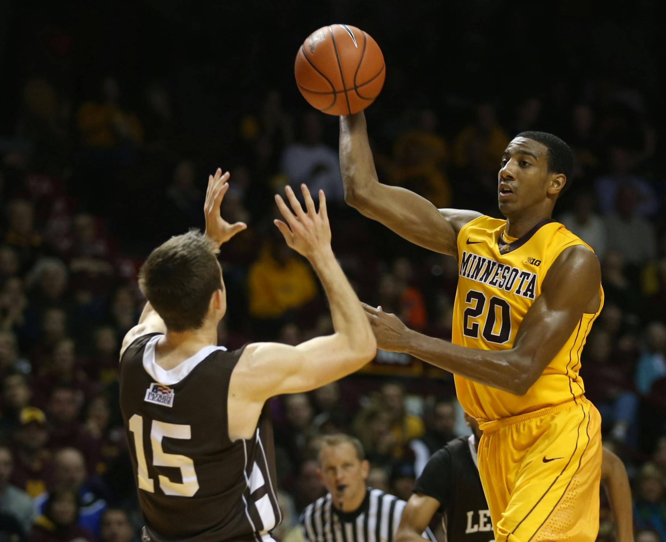 Gophers Austin Hollins passed the ball to a teammate over the head of Lehigh's Corey Schaefer during the second half at Williams Arena in Minneapolis, Min., Friday, November 8, 2013. Gophers won over Lehigh 81-62.