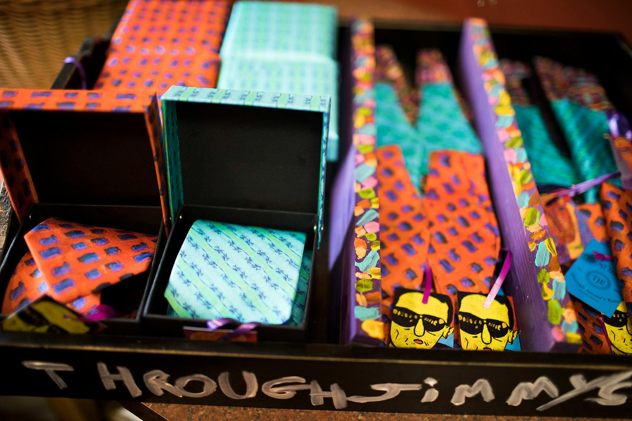 Scarves and bowties that were made from Jimmy Reagan's paintings.