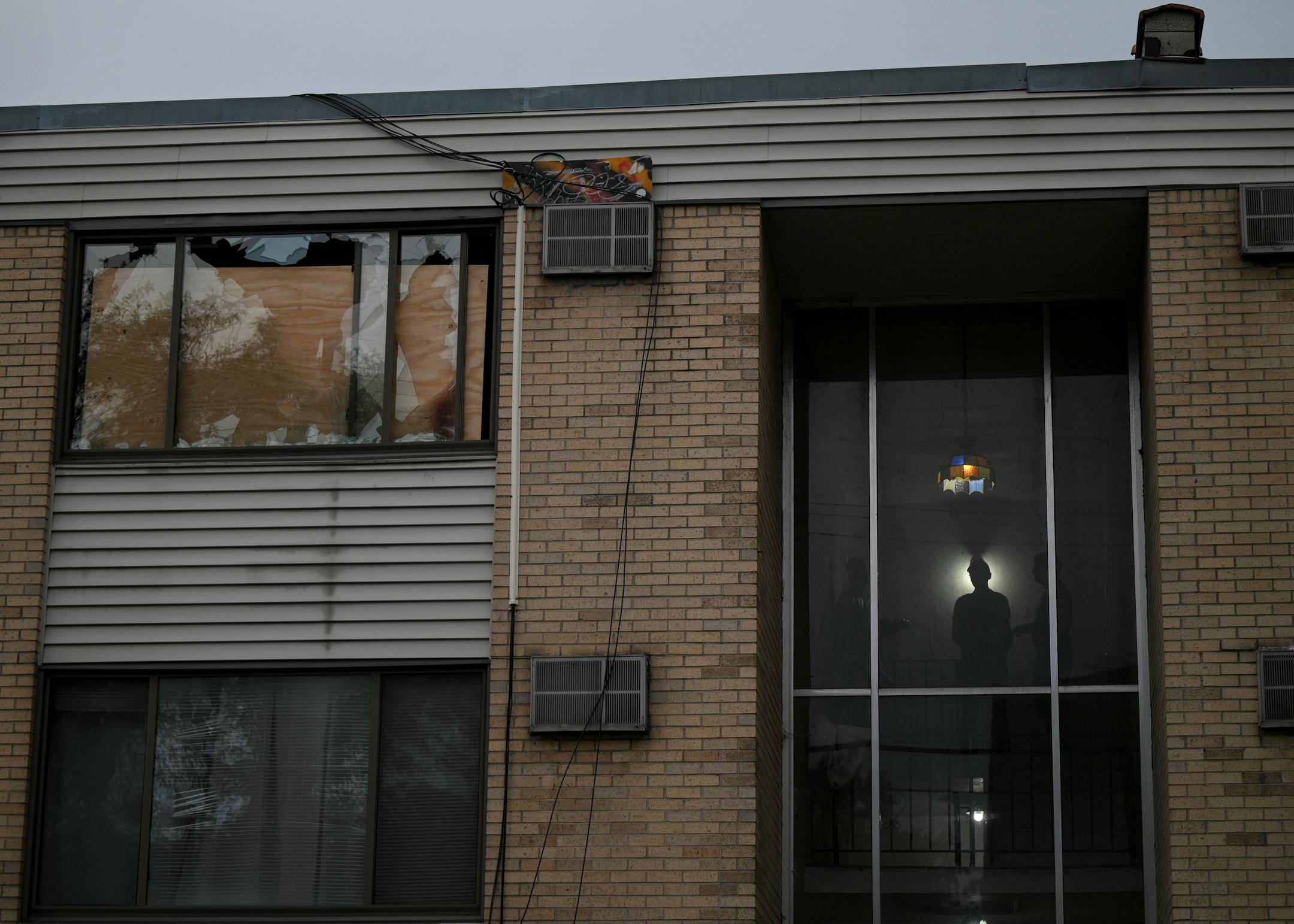 People gathered Thursday in the stairwell near the apartment where Andrew Tekle Sundberg was killed.
