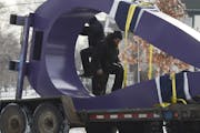 Workers install the "Purple Raindrop" art piece at Farview Park.
