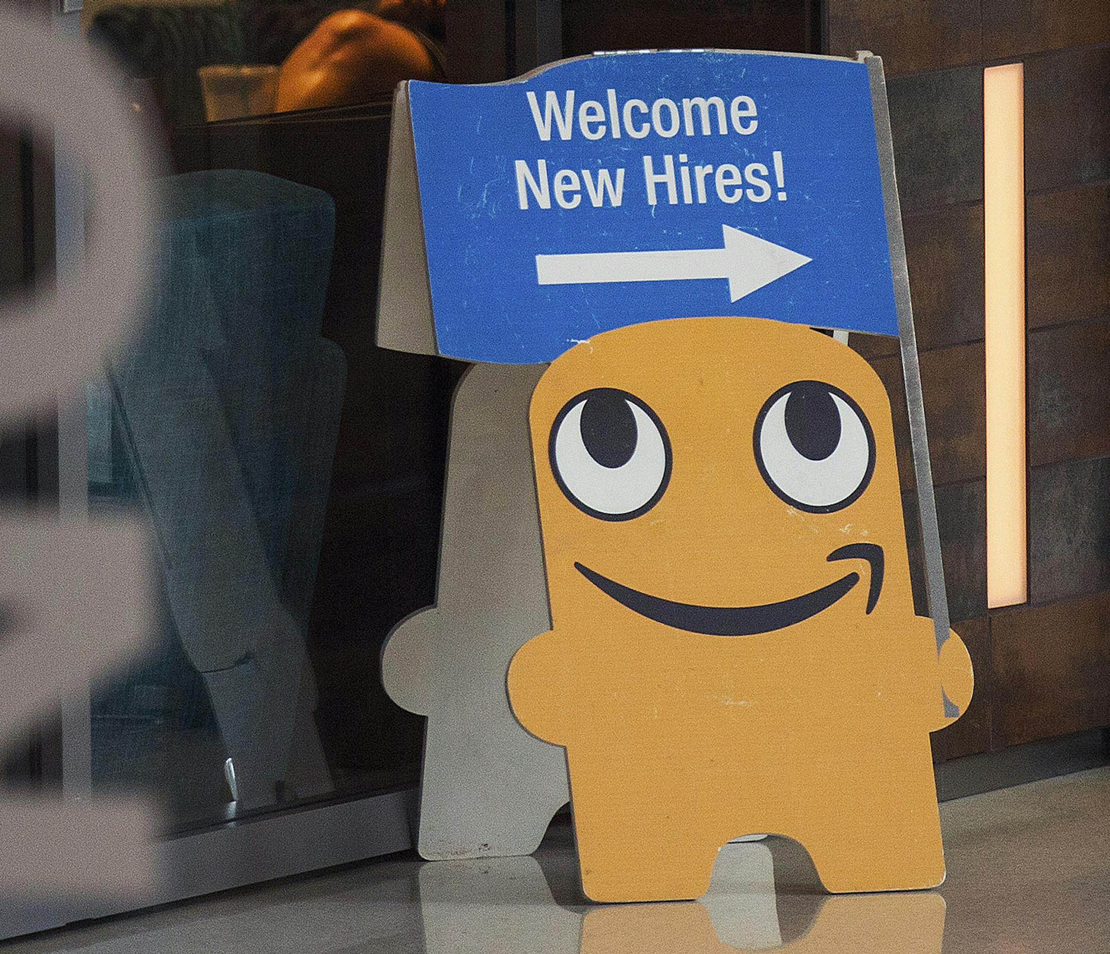A sign directs new Amazon employees toward an orientation session, on the retailer&#xed;s campus in Seattle, July 20, 2015. Pushing the boundaries of what is deemed acceptable, Amazon is conducting an experiment in just how far it can push its white-collar employees to achieve its ever-expanding ambitions. (Ruth Fremson/The New York Times) ORG XMIT: MIN2015081911443622