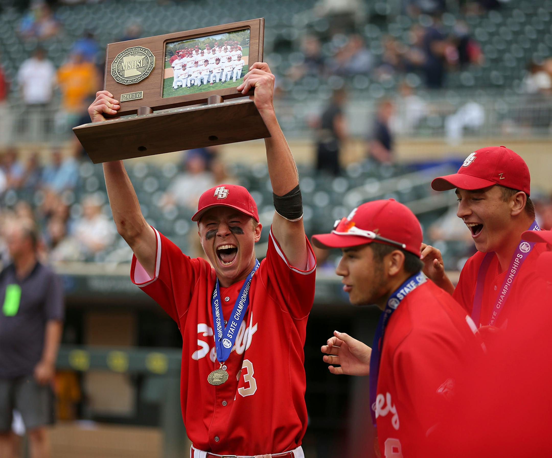 Henry Sibley's Dillon Orth held up the Class 3A trophy at the end of the awards ceremony after the Warriors win.