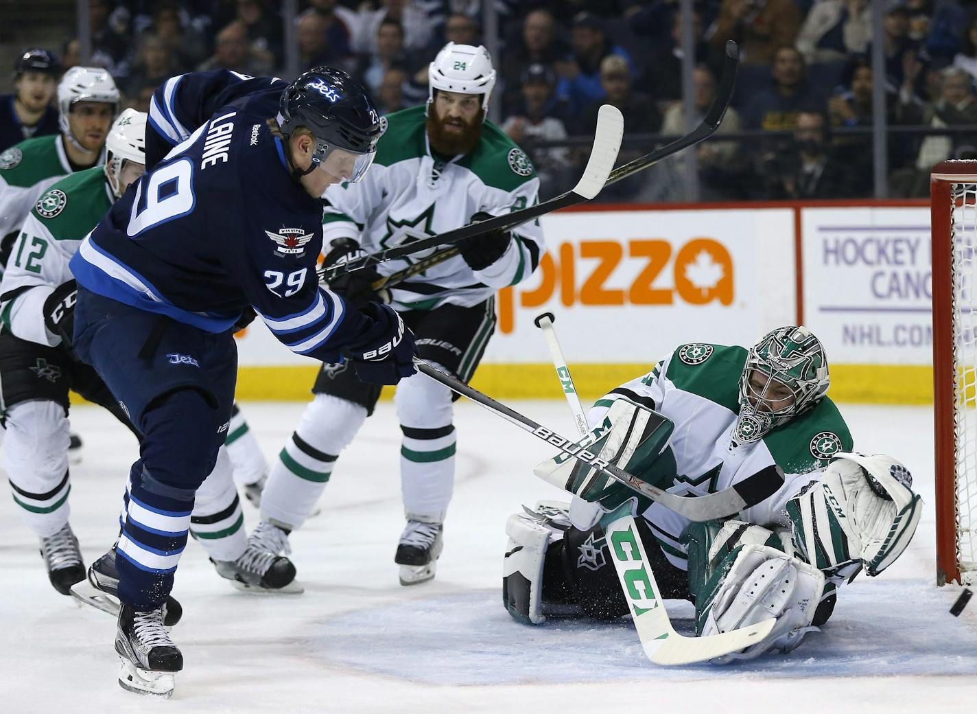 Winnipeg Jets' Patrik Laine (29) scores his second goal of the night against Dallas Stars goaltender Kari Lehtonen (32) as Jordie Benn (24) and Radek Faksa (12) defend during the second period of an NHL hockey game Tuesday, Nov. 8, 2016, Winnipeg, Manitoba. (John Woods/The Canadian Press via AP)