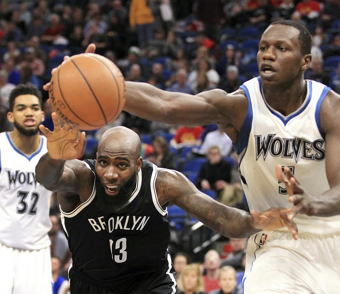 Brooklyn Nets center Quincy Acy (13) and Minnesota Timberwolves center Gorgui Dieng vie for a loose ball during the first quarter of an NBA basketball in Minneapolis, Saturday, Jan. 28, 2017. (AP Photo/Andy Clayton-King)