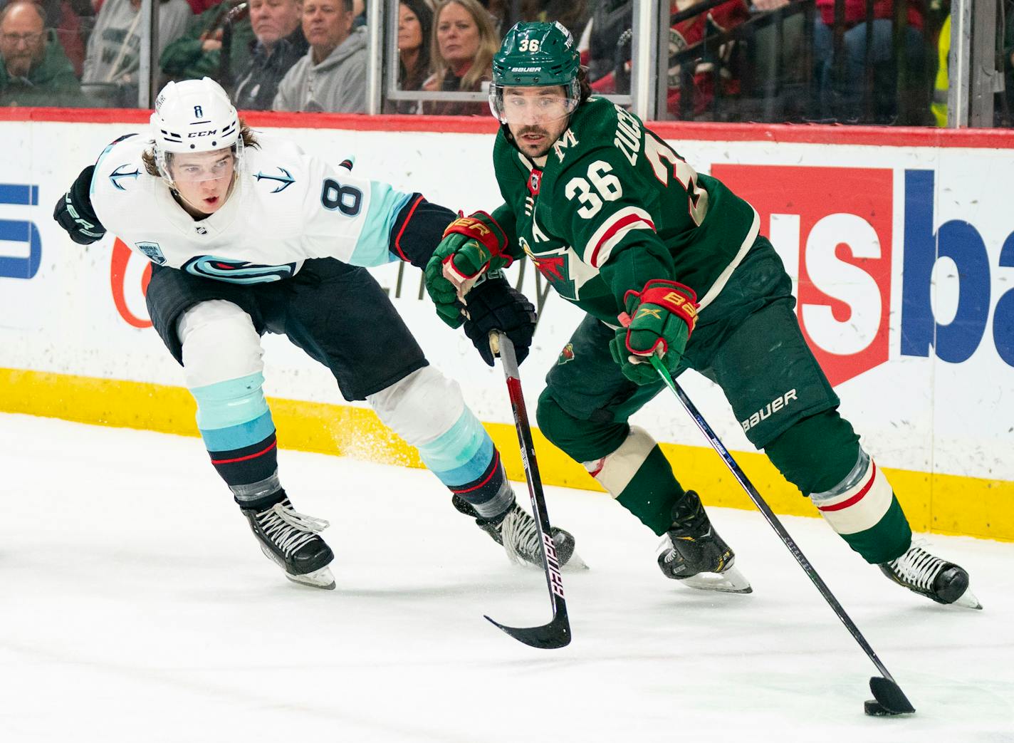 Minnesota Wild right wing Mats Zuccarello (36) carries the puck with one hand away from Seattle Kraken defenseman Cale Fleury (8) in the second period Friday, April, 22, 2022 at Xcel Energy Center in St. Paul, Minn. ]