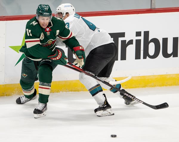 Wild winger Zach Parise and the Sharks' John Leonard fought for the puck in the second period. Parise scored the game's first goal, but the Sharks pre