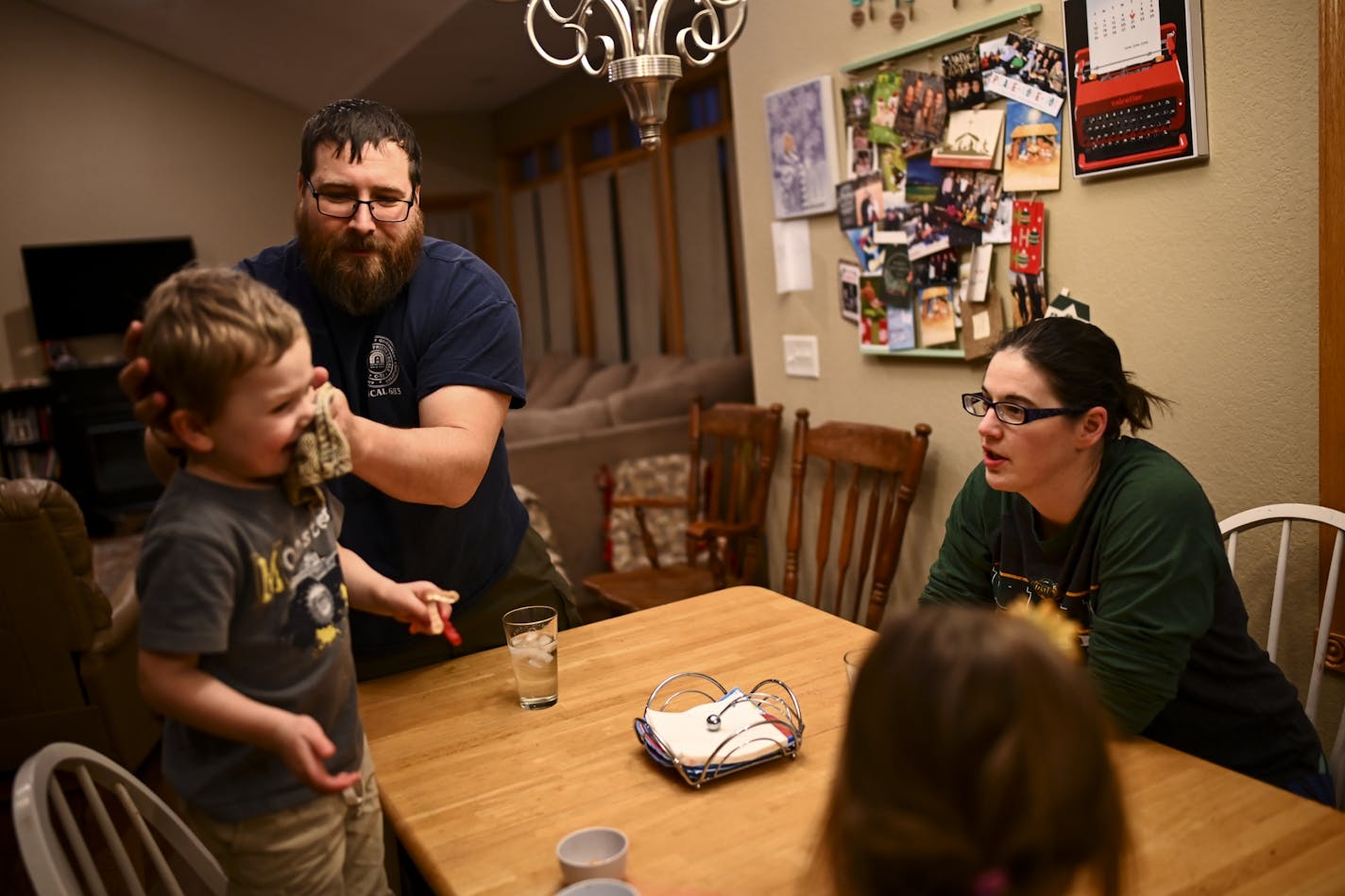 Steve Denzine wiped off the face of his 3-year old son, Robbie, after dinner Wednesday night alongside his wife, Beth, and 6-year old daughter, Stella.