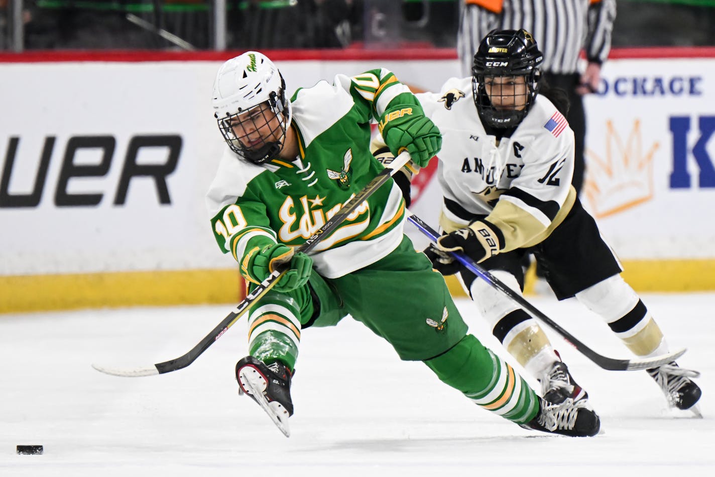 Edina forward Hannah Halverson (10) and Andover forward Isa Goettl (12) battle for the puck during the first period of a Class 2A girls' hockey state tournament semifinal game Friday, Feb. 24, 2023 at the Xcel Energy Center in St. Paul, Minn.. ] AARON LAVINSKY • aaron.lavinsky@startribune.com