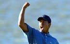 Chaska, Mn August 16, 2002 Third round play at the PGA Championship at Hazeltine. Tiger Woods pumps his fist to a cheering crowd after sinking a long 