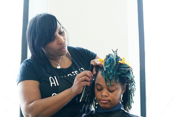 Stylist Erika Carter worked on AK Wright's hair Wednesday morning at the Beauty Lounge in south Minneapolis.