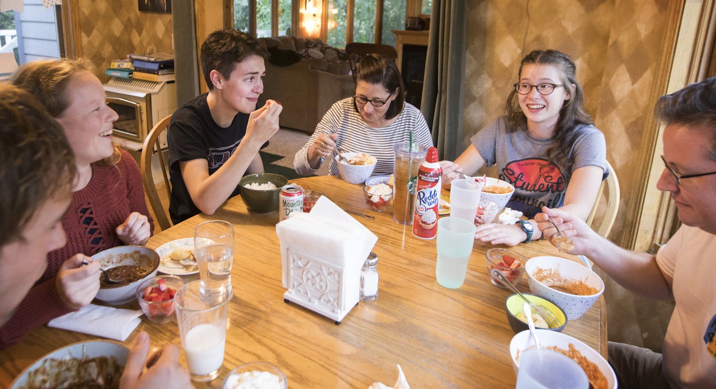 Gideon, clockwise from center top, sits down to family dinner with Carolyn Anderson, Lucy Anderson, 16, Jeff Anderson, and the Anderson family's former German exchange student Nicola Stieneker, left in red, who is visiting the family with her fiancee Moritz Teigelkotter, bottom left. ] LEILA NAVIDI &#xef; leila.navidi@startribune.com BACKGROUND INFORMATION: Tuesday, September 5, 2017. Gideon, 22, was living in a homeless shelter in Anoka for six months before being placed in Jeff and Carolyn And