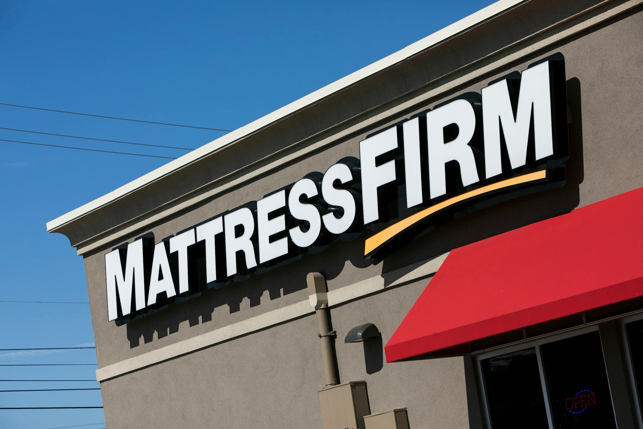 A logo sign outside of a Mattress Firm retail store in Altoona, Pennsylvania on September 23, 2017. Photo by Kristoffer Tripplaar(Sipa via AP Images)