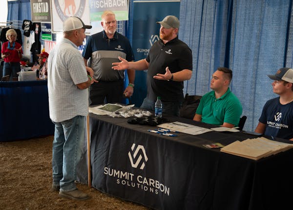 Scott O’Konek, project manager for Summit Carbon Solutions, center, talked to people at Farmfest about his company’s carbon pipeline project on Au