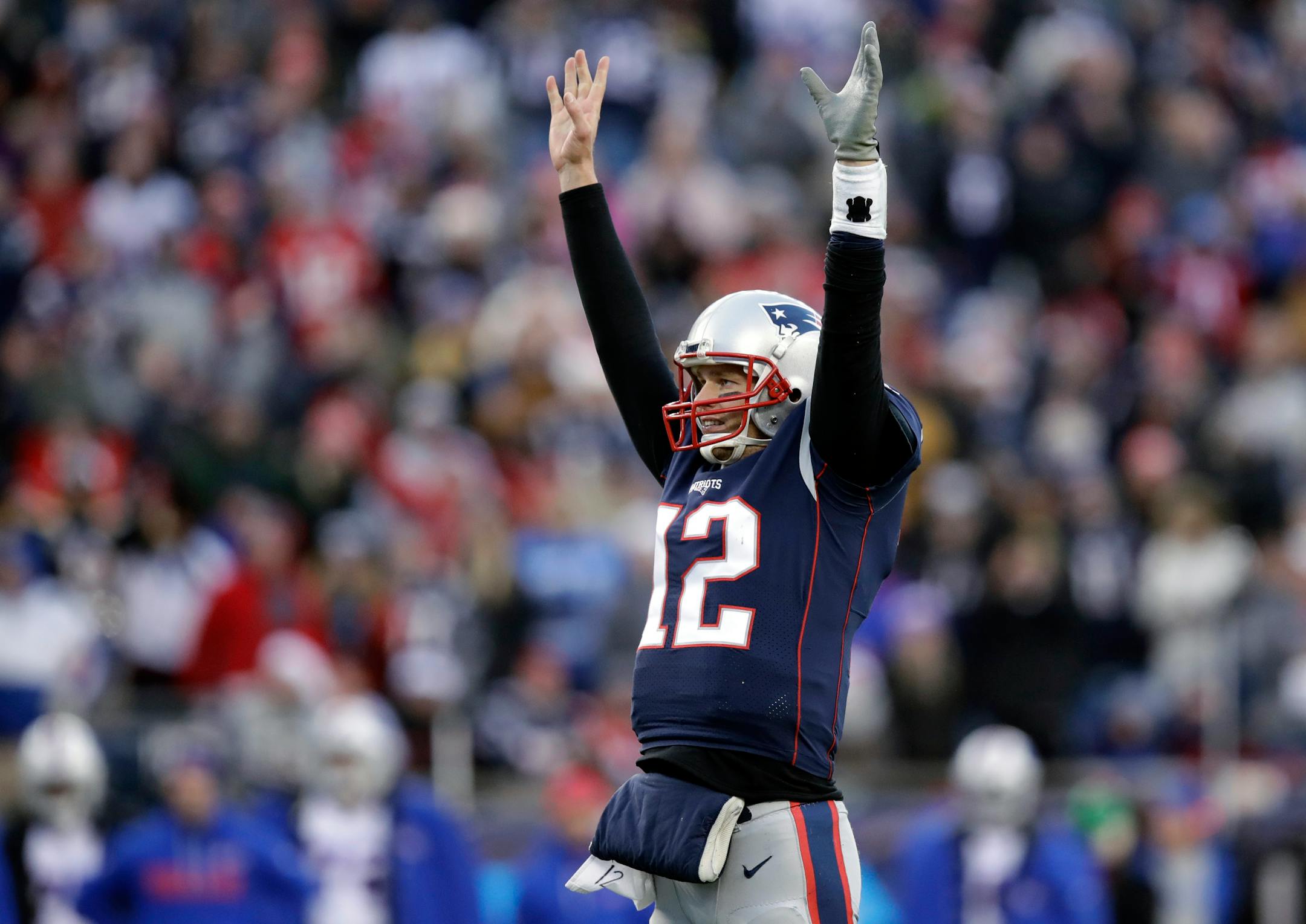 FILE - In this Dec. 24, 2017, file photo, New England Patriots quarterback Tom Brady celebrates a touchdown by running back Dion Lewis during the second half of the team's NFL football game against the Buffalo Bills in Foxborough, Mass. Brady's .774 regular season winning percentage ranks first in the Super Bowl era among quarterbacks with at least 50 starts. With 249 victories overall, including playoffs, he's won almost as many games in two decades as the Tampa Bay Buccaneers have won (273) in