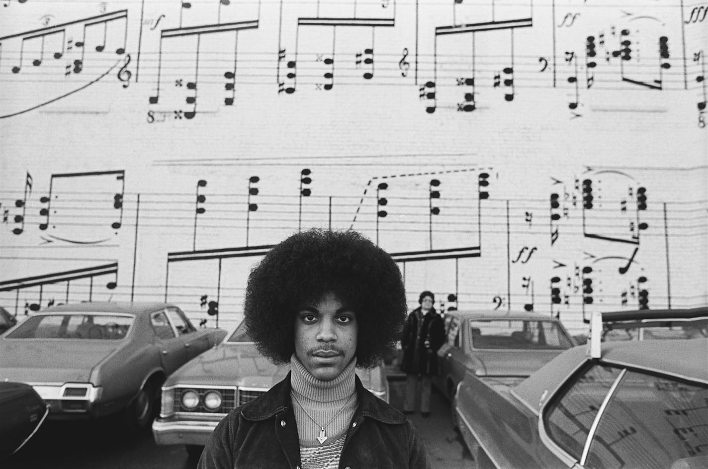 In 1977, a year before the release of Prince's debut album "For You," Robert Whitman was brought in to do several photo shoots of the soon to be iconic singer in his home surroundings. How better to represent Prince than in a large black-and-white portrait of him framed by the famous Schmitt Music Mural in downtown Minneapolis.