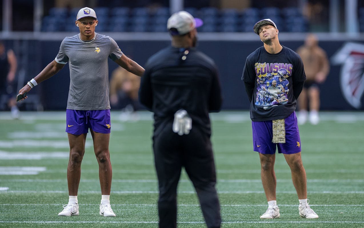 Vikings quarterbacks Joshua Dobbs (15), left, and Vikings quarterback Jaren Hall (16), right, warm up before they take on the Atlanta Falcons at Merce