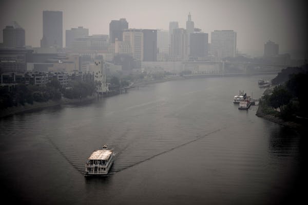 A boat goes north on the Mississippi River as heavy smoke blankets downtown St.Paul Wednesday June 14,2023 in St. Paul Minn.
