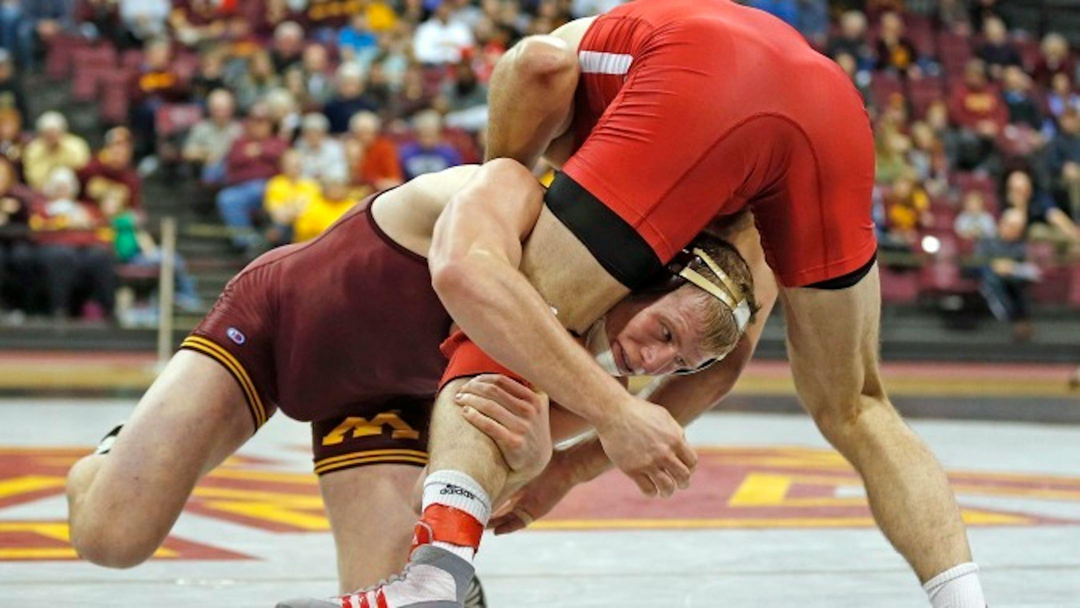 Brett Pfarr, left, led off the Gophers' 28-9 victory over Indiana in Bloomington, Ind., on Sunday with a technical fall over Norman Conley 24-9 and recording 11 takedowns in the match. Photo is courtesy of the University of Minnesota. For more Gophers photos, go to gophersports.com.