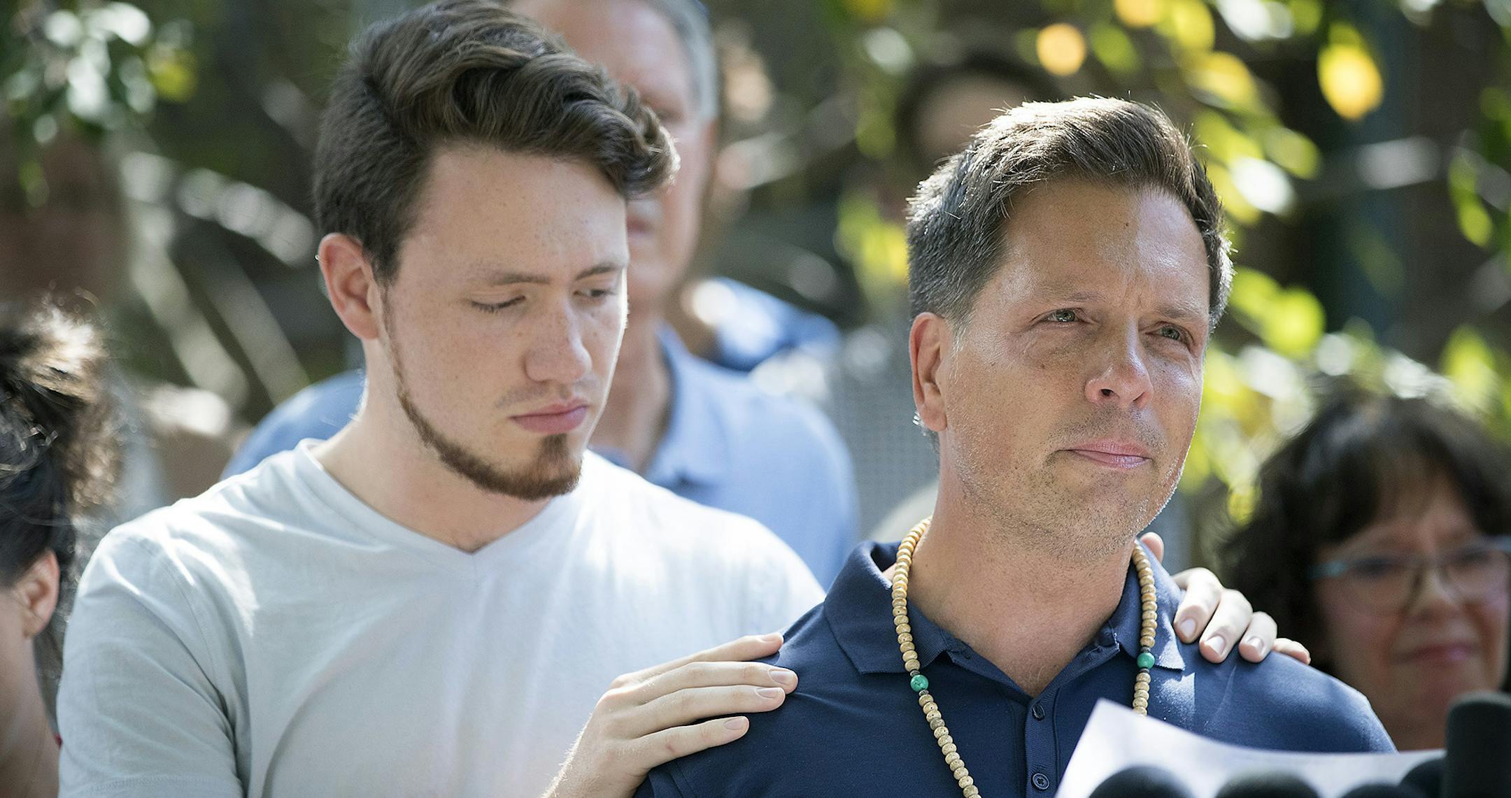 Don Damond is comforted by his son Zach Damond as he made a statement to the press near his home after Minneapolis police officer shot and killed his fiance Justine Damond, Monday, July 17, 2017 in Minneapolis, MN. ] ELIZABETH FLORES ï liz.flores@startribune.com ORG XMIT: MIN1707171605372751