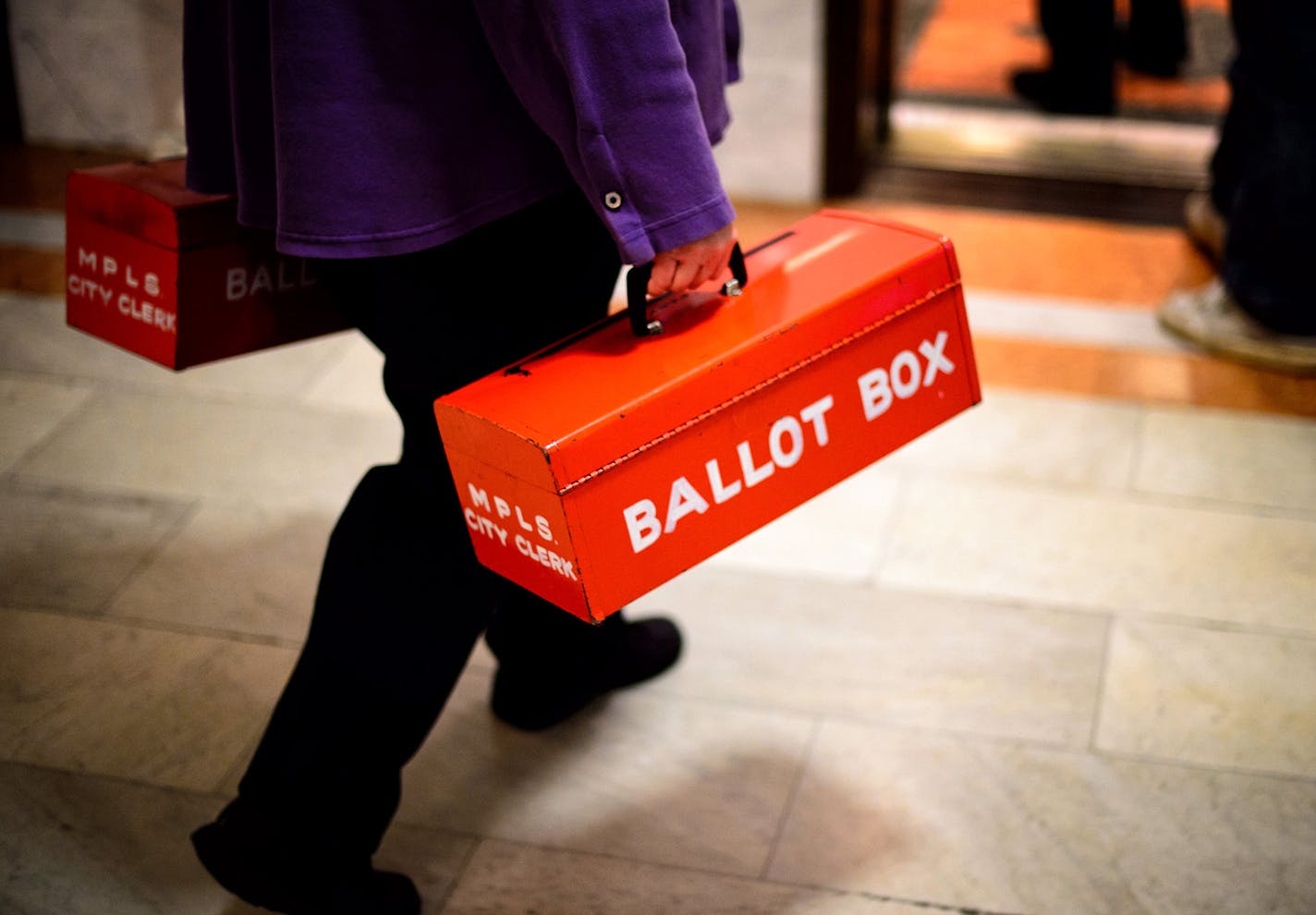 Ballots cast at Minneapolis City Hall Monday are carried up to the City Clerk's office for processing. ] GLEN STUBBE * gstubbe@startribune.com Monday, November 3, 2014 ORG XMIT: MIN1411031548093609