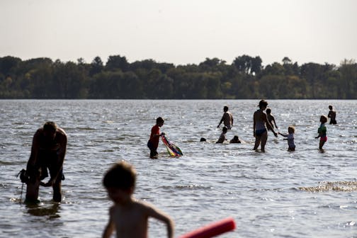 Swimmers enjoyed the water at Lake Nokomis Beach in 2017. The south Minneapolis lake's two beaches are closed until further notice.