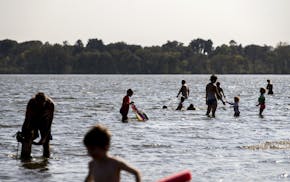 Swimmers enjoyed the water at Lake Nokomis Beach in 2017. The south Minneapolis lake's two beaches are closed until further notice.