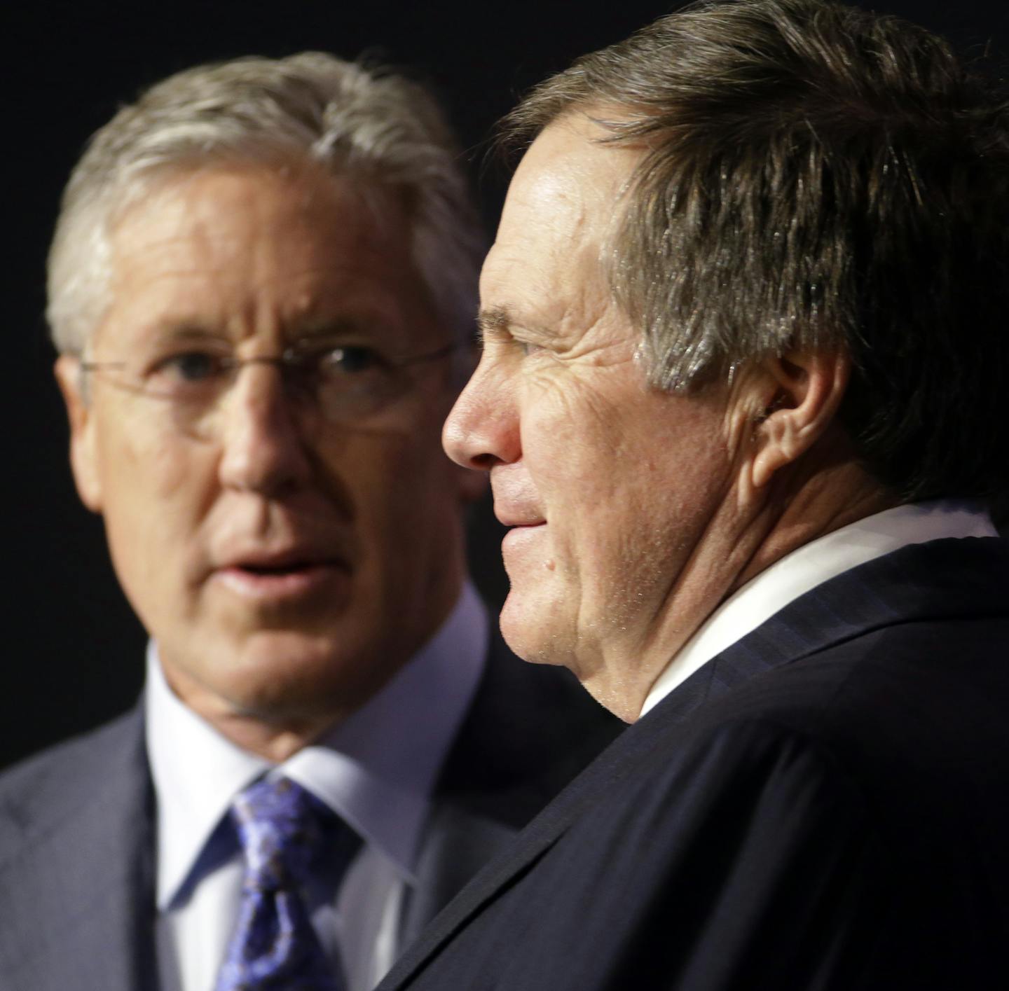 Seattle Seahawks head coach Pete Carroll, left, and New England Patriots head coach Bill Belichick participate in a news conference for NFL Super Bowl XLIX football game Friday, Jan. 30, 2015, in Phoenix. (AP Photo/Charlie Riedel) ORG XMIT: NFL116