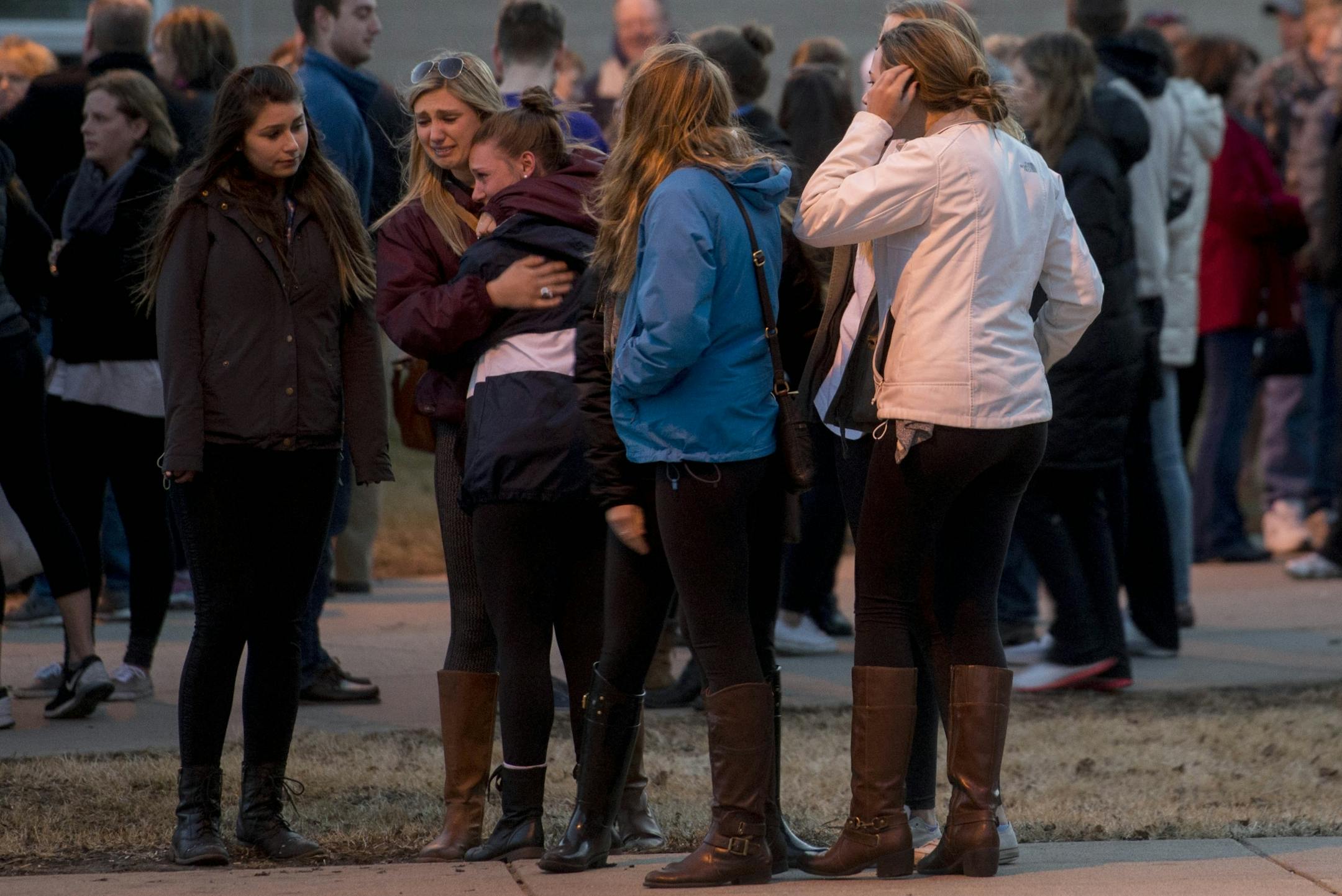Vigil attendees for Jennifer Houle shared hugs Sunday. On Monday, Minneapolis police said the University of Minnesota student who went missing last week was captured on video entering the Mississippi River off the 10th Avenue Bridge.