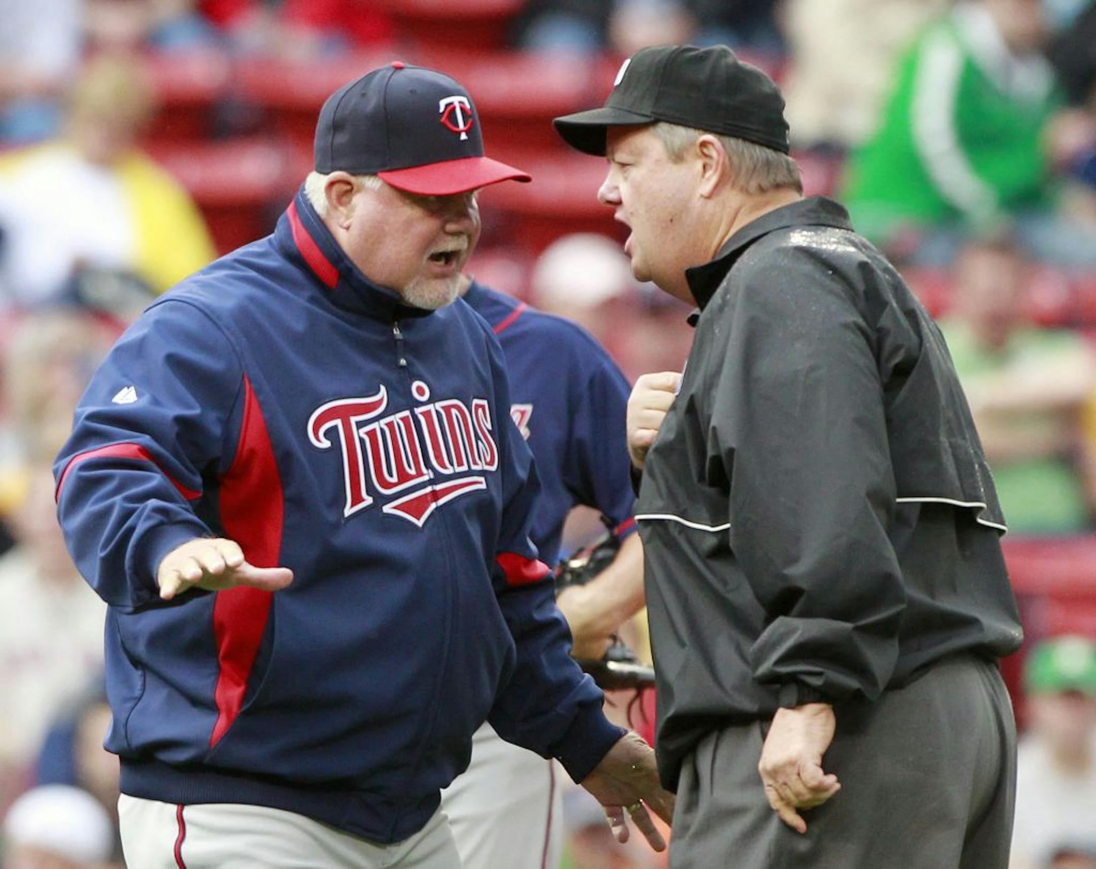 Minnesota Twins manager Ron Gardenhire, left, talks to umpire Joe West about a call at second base in the third inning of a baseball game against the Boston Red Sox, Saturday, May 7, 2011, in Boston.